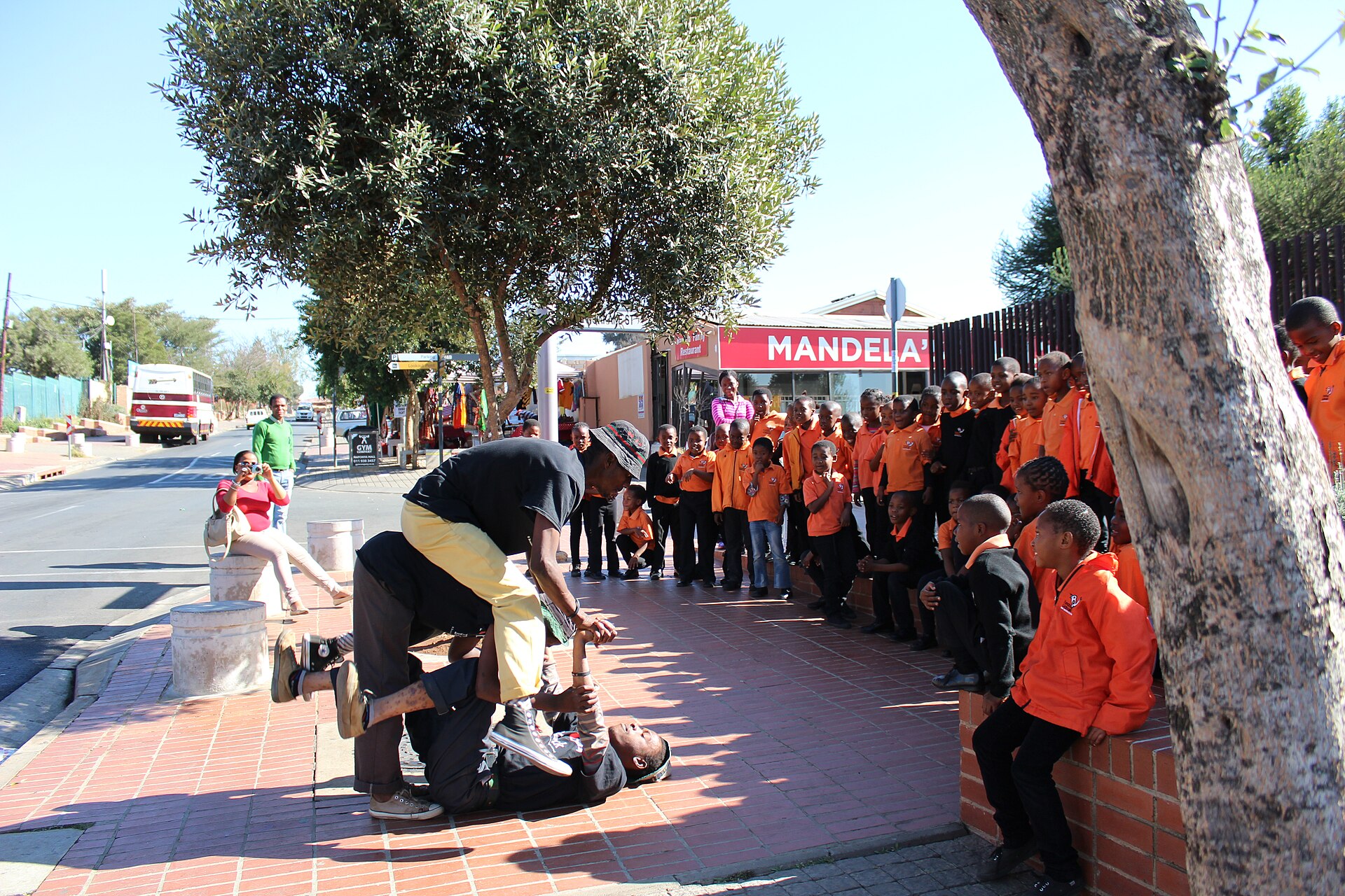 Street performers dancing for visitors on Vilakazi Street in Soweto, Johannesburg